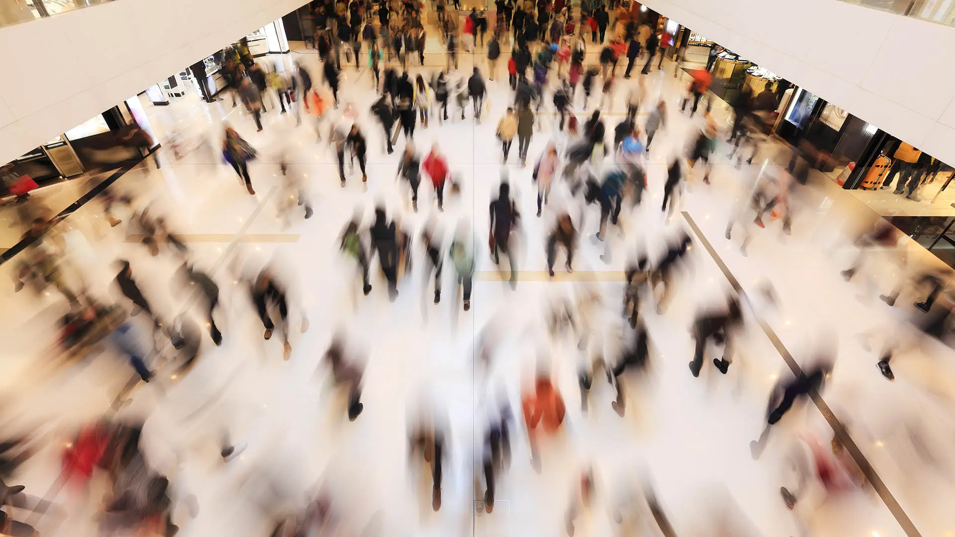 Aerial view of a busy public space with crowds of people in motion, illustrating how human trafficking can occur in plain sight in everyday environments.